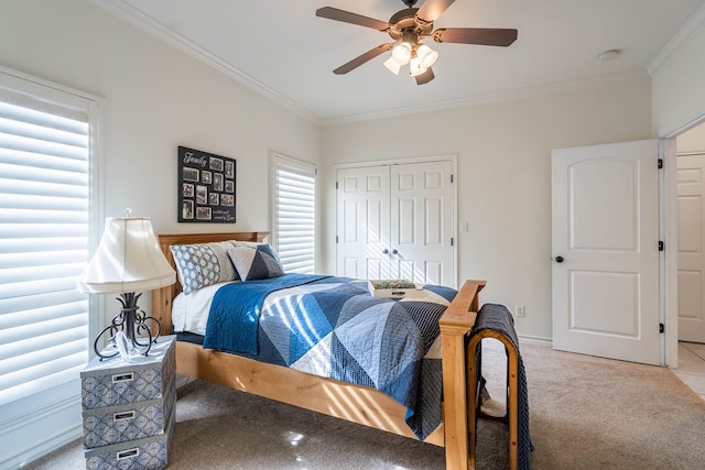 bedroom with crown molding, light carpet, ceiling fan, and a closet