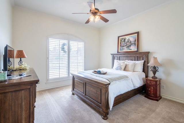 bedroom with ornamental molding, light colored carpet, and ceiling fan