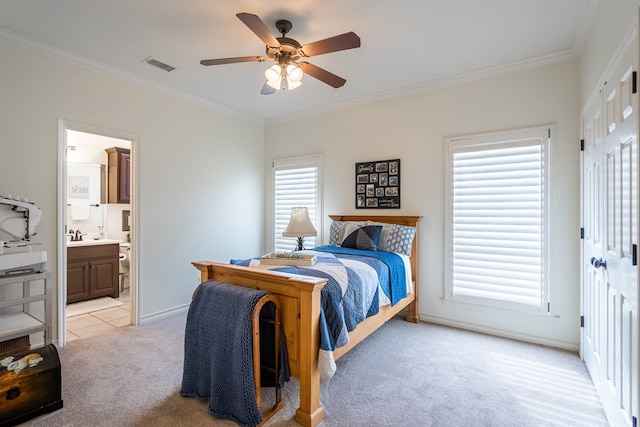 bedroom with crown molding, light colored carpet, ceiling fan, and ensuite bath