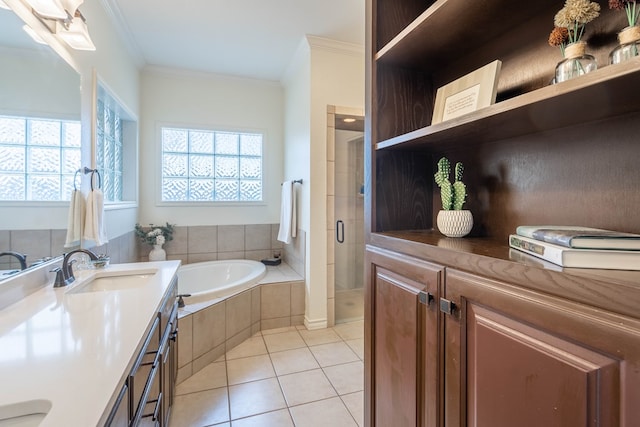 bathroom with tile patterned floors, ornamental molding, plus walk in shower, and vanity