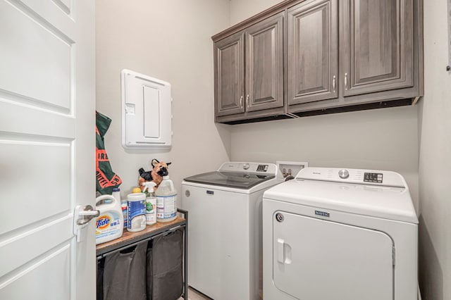 clothes washing area with cabinet space and washer and clothes dryer