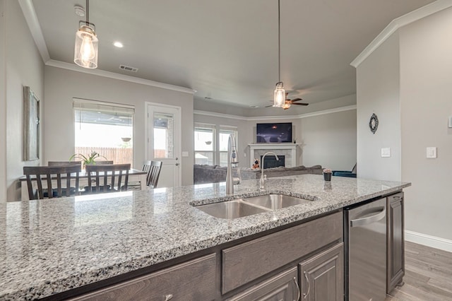 kitchen featuring visible vents, ceiling fan, light wood-type flooring, a sink, and dishwasher