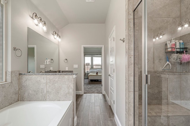 bathroom with vaulted ceiling, a shower stall, ensuite bath, and a bath