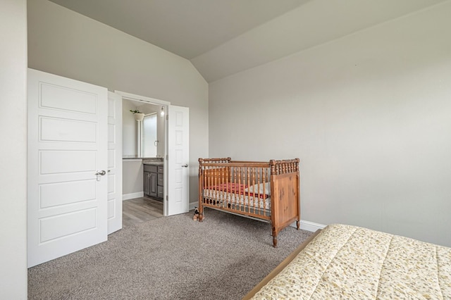 bedroom featuring baseboards, carpet flooring, and lofted ceiling