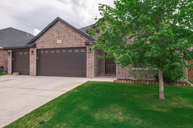 view of front facade with a garage, concrete driveway, a front lawn, and brick siding