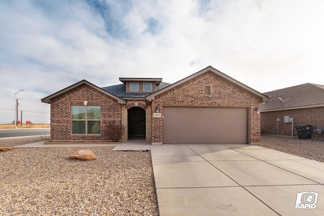 traditional-style home featuring driveway, brick siding, and an attached garage