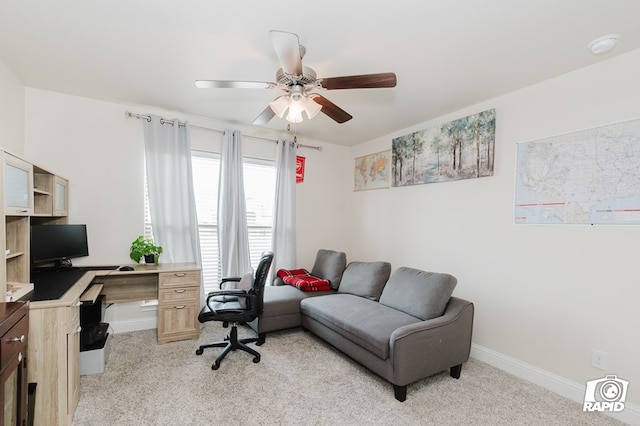 office space featuring light carpet, ceiling fan, and baseboards