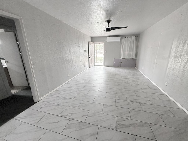 unfurnished living room featuring ceiling fan and a textured ceiling