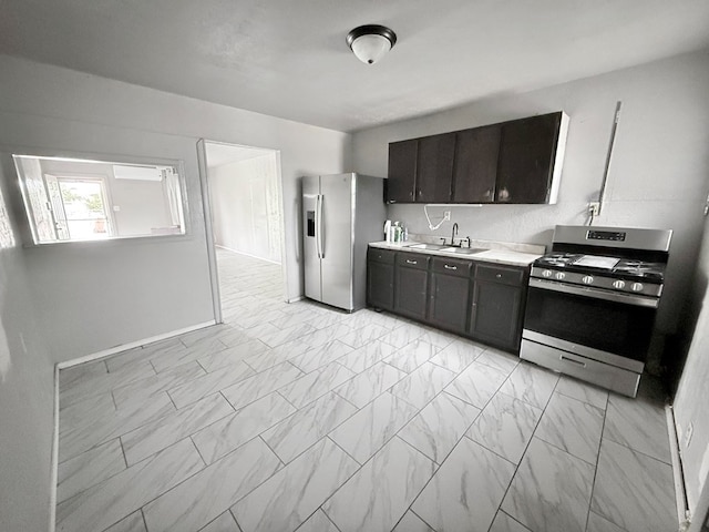 kitchen featuring stainless steel appliances, sink, and dark brown cabinetry