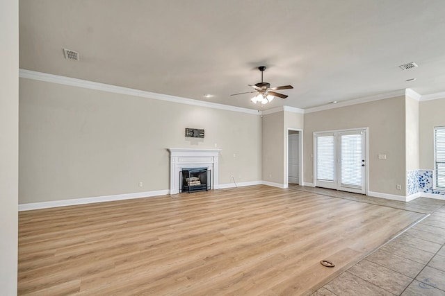 unfurnished living room with ceiling fan, ornamental molding, and light hardwood / wood-style floors