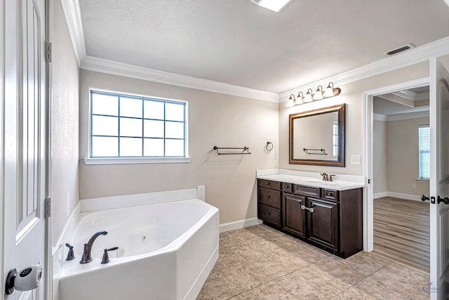 bathroom with ornamental molding, a tub, tile patterned floors, and vanity