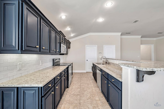 kitchen featuring a breakfast bar, sink, crown molding, and stainless steel appliances