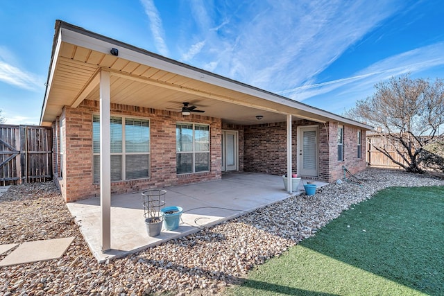 rear view of house featuring ceiling fan and a patio