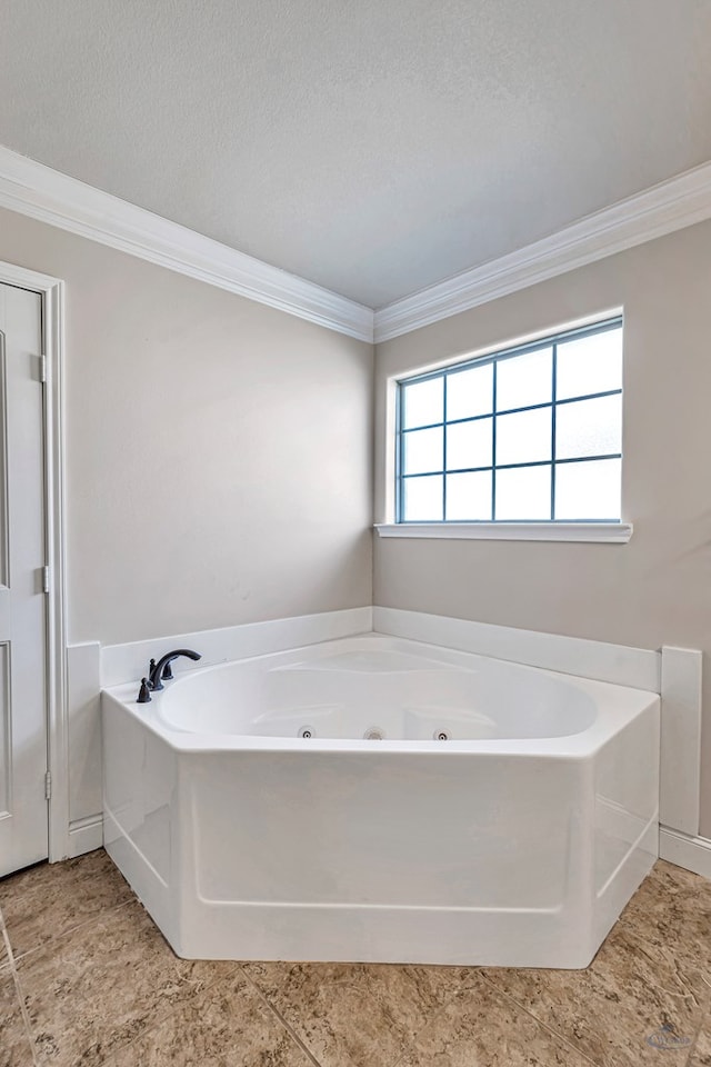 bathroom with a bathtub, ornamental molding, and a textured ceiling