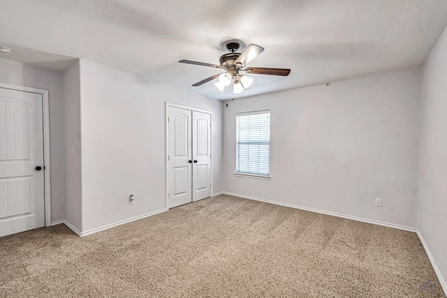 empty room with ceiling fan and carpet floors