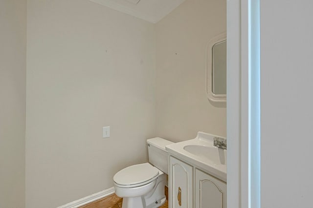 710 W Nobles Ave, Midland, TX 79701 - half bathroom featuring vanity, toilet, and baseboards