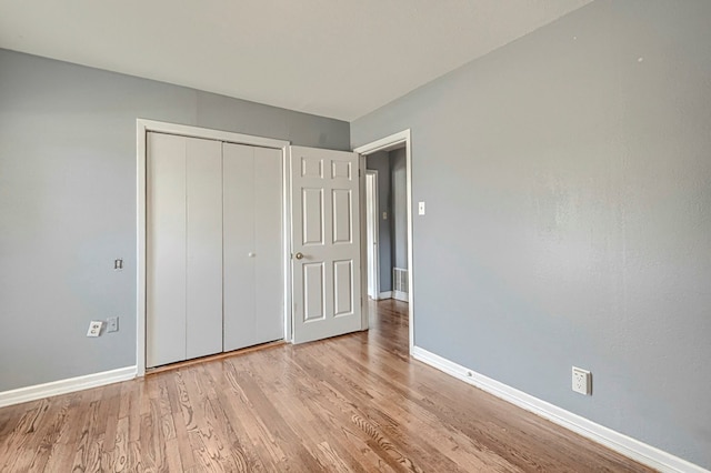 710 W Nobles Ave, Midland, TX 79701 - unfurnished bedroom featuring baseboards, light wood-style floors, and a closet