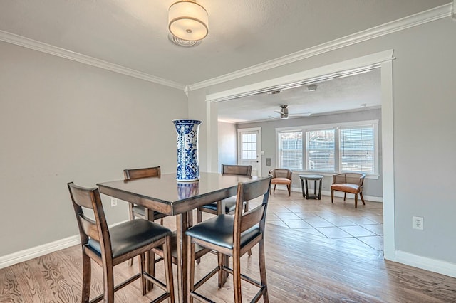 710 W Nobles Ave, Midland, TX 79701 - dining area featuring baseboards, crown molding, wood finished floors, and ceiling fan