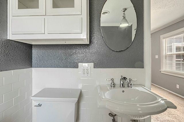 710 W Nobles Ave, Midland, TX 79701 - half bathroom with tile walls and a sink