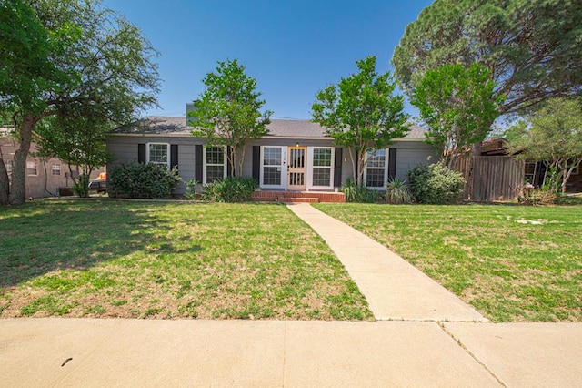 710 W Nobles Ave, Midland, TX 79701 - ranch-style house with a front lawn
