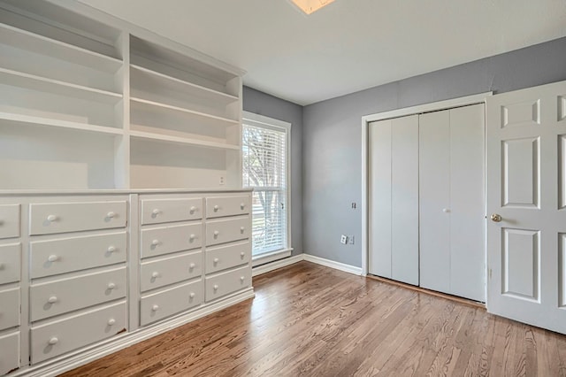 710 W Nobles Ave, Midland, TX 79701 - unfurnished bedroom with wood finished floors, baseboards, and a closet