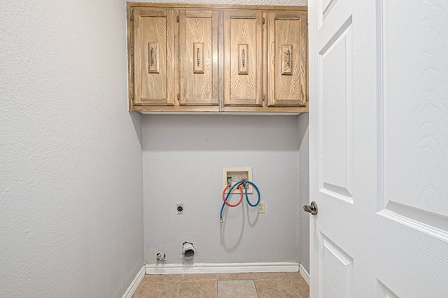 laundry room featuring cabinet space, hookup for a washing machine, electric dryer hookup, and baseboards