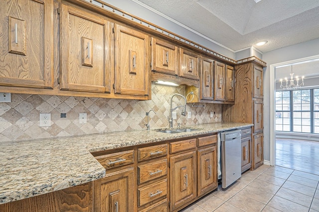 kitchen with light tile patterned floors, brown cabinetry, dishwasher, backsplash, and a sink