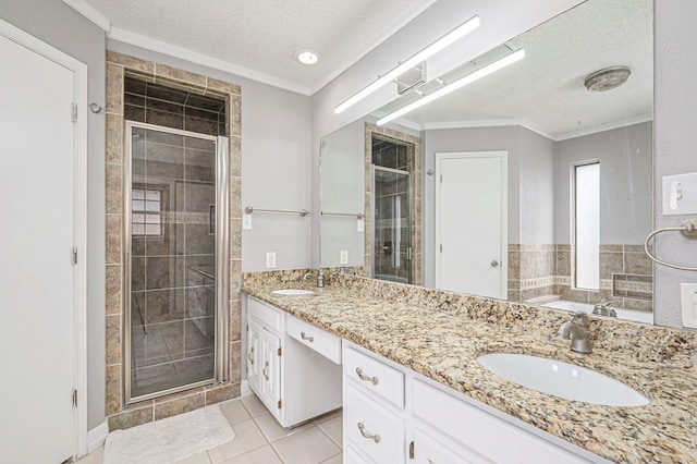 bathroom featuring ornamental molding, a sink, and a shower stall