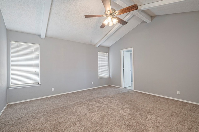 spare room with a textured ceiling, baseboards, and vaulted ceiling with beams