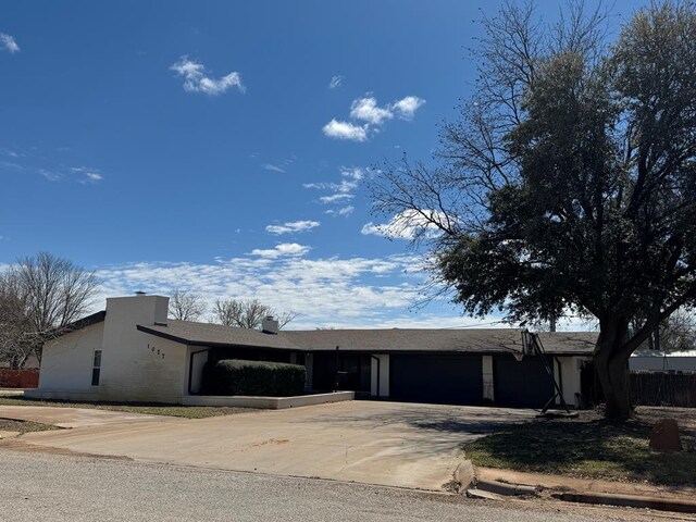single story home featuring an attached garage and concrete driveway
