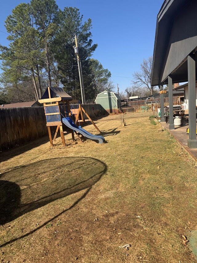 view of yard featuring fence and a playground