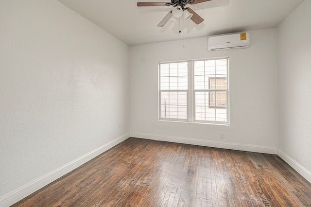 empty room featuring ceiling fan, a wall mounted air conditioner, hardwood / wood-style flooring, and baseboards