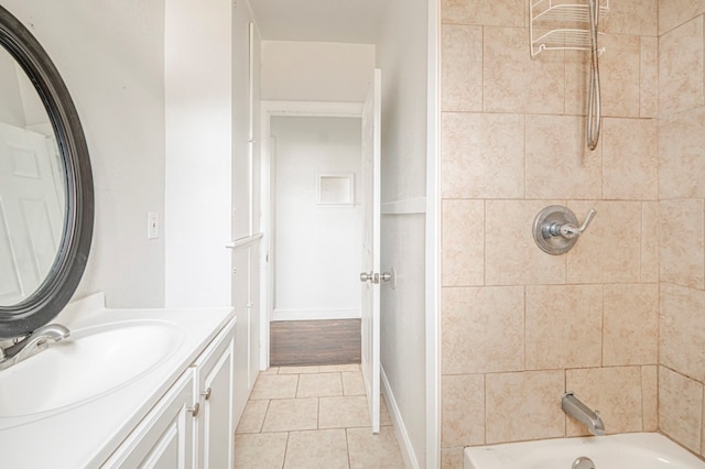 full bath featuring tile patterned flooring, baseboards, vanity, and shower / tub combination