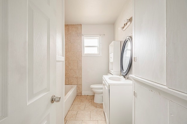 bathroom with toilet, tile patterned floors, and vanity