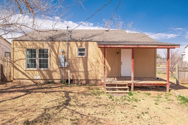 back of house featuring crawl space, fence, and roof with shingles