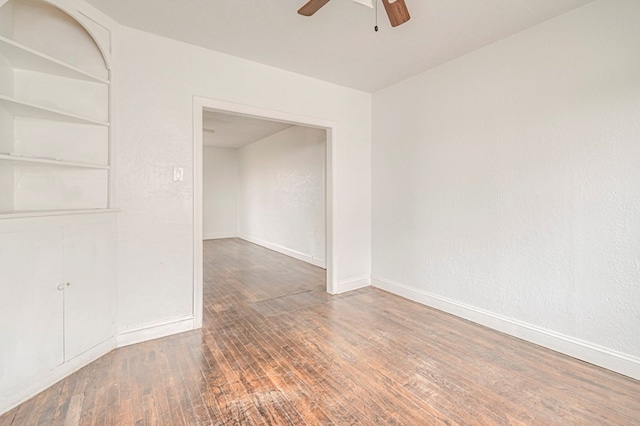 spare room with ceiling fan, hardwood / wood-style flooring, and baseboards