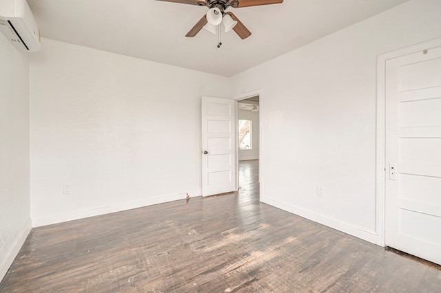 unfurnished room featuring a ceiling fan, baseboards, wood finished floors, and a wall mounted air conditioner