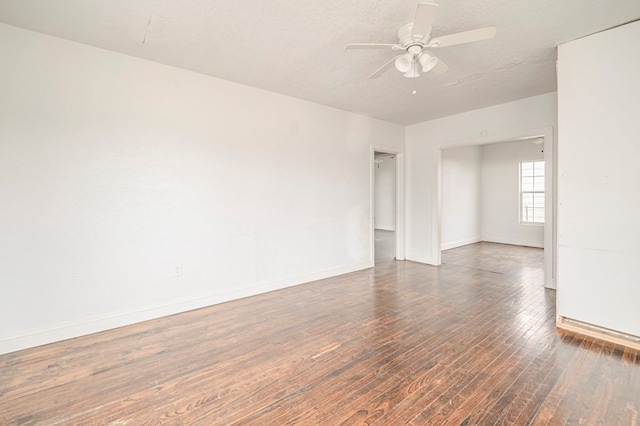 spare room featuring baseboards, a textured ceiling, a ceiling fan, and wood finished floors