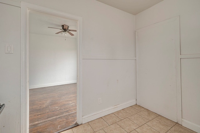 unfurnished room with light tile patterned floors and a ceiling fan