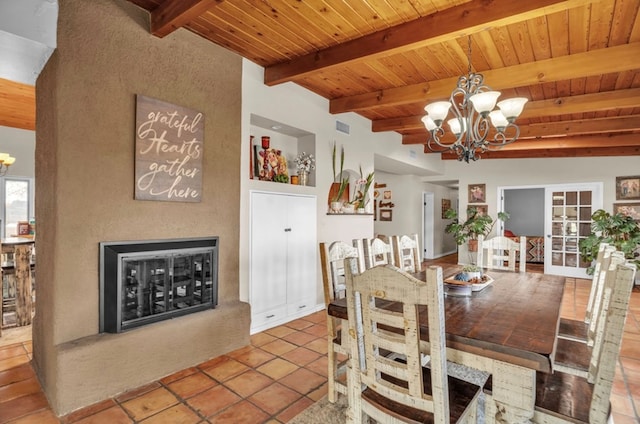 dining space featuring tile patterned floors, beamed ceiling, visible vents, a notable chandelier, and wood ceiling