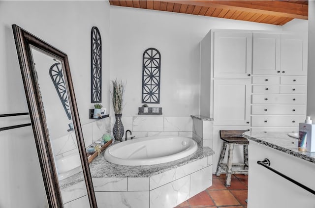 full bath featuring tile patterned flooring, beamed ceiling, wood ceiling, and a garden tub