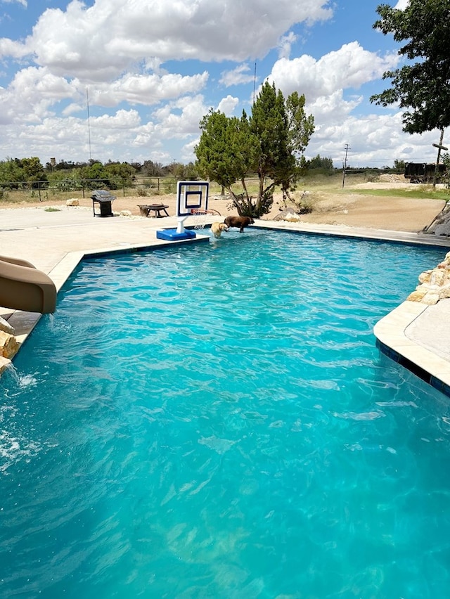 outdoor pool featuring a water slide