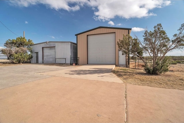 detached garage featuring fence