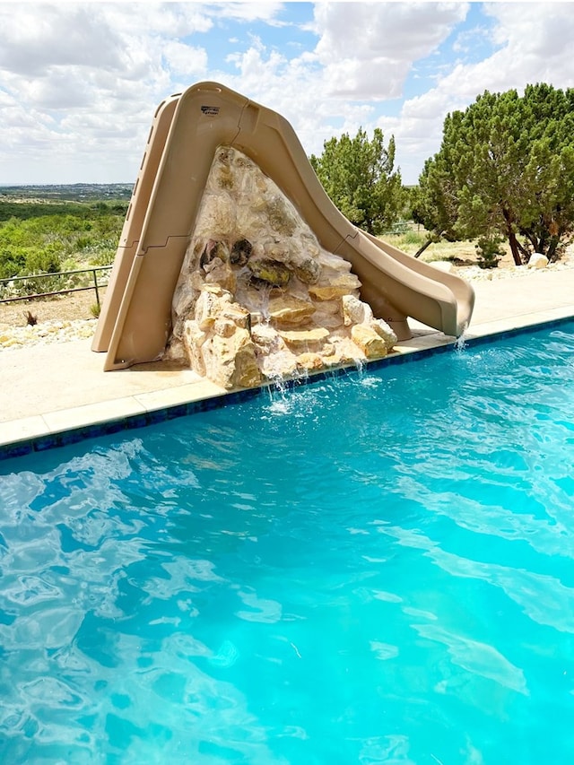 outdoor pool with a water slide