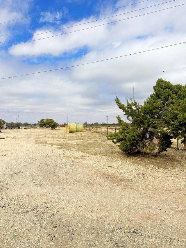 view of yard featuring a rural view and fence