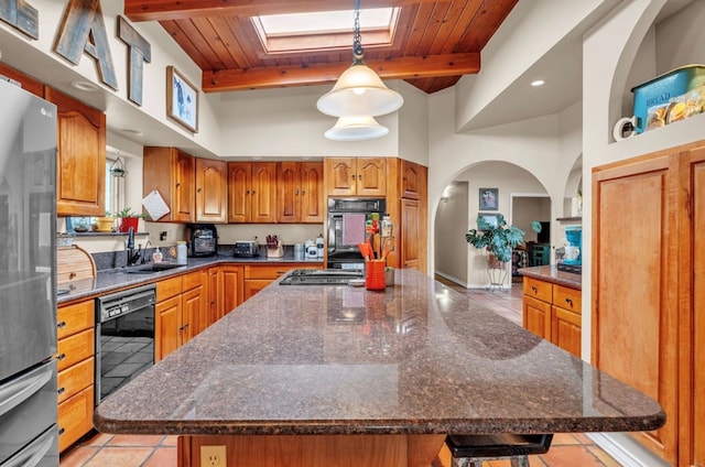 kitchen featuring beam ceiling, wooden ceiling, black appliances, and brown cabinetry