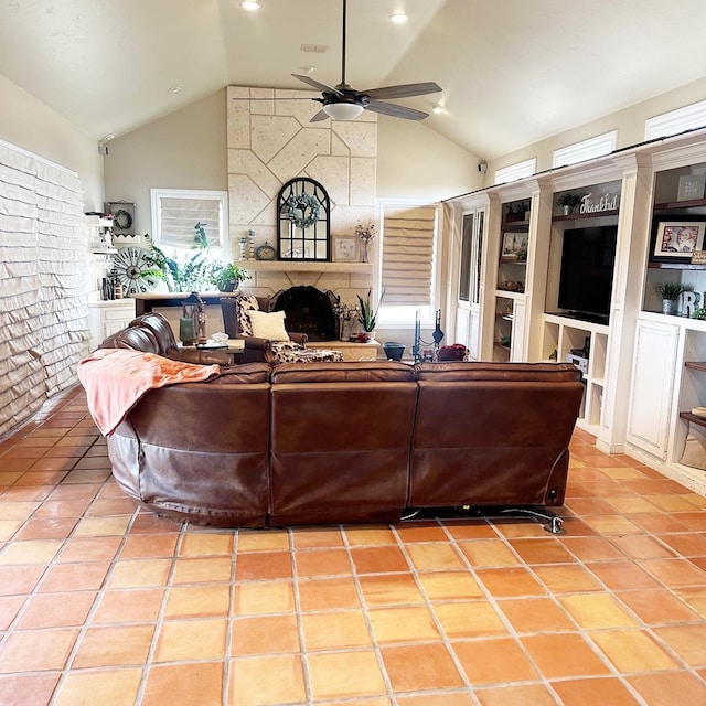 living area featuring light tile patterned floors, visible vents, high vaulted ceiling, and ceiling fan