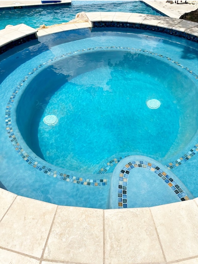 view of pool featuring a pool with connected hot tub