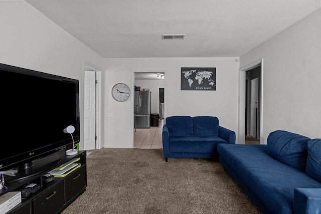 living room featuring light carpet and a textured ceiling