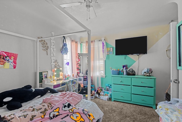 carpeted bedroom featuring a textured ceiling and ceiling fan